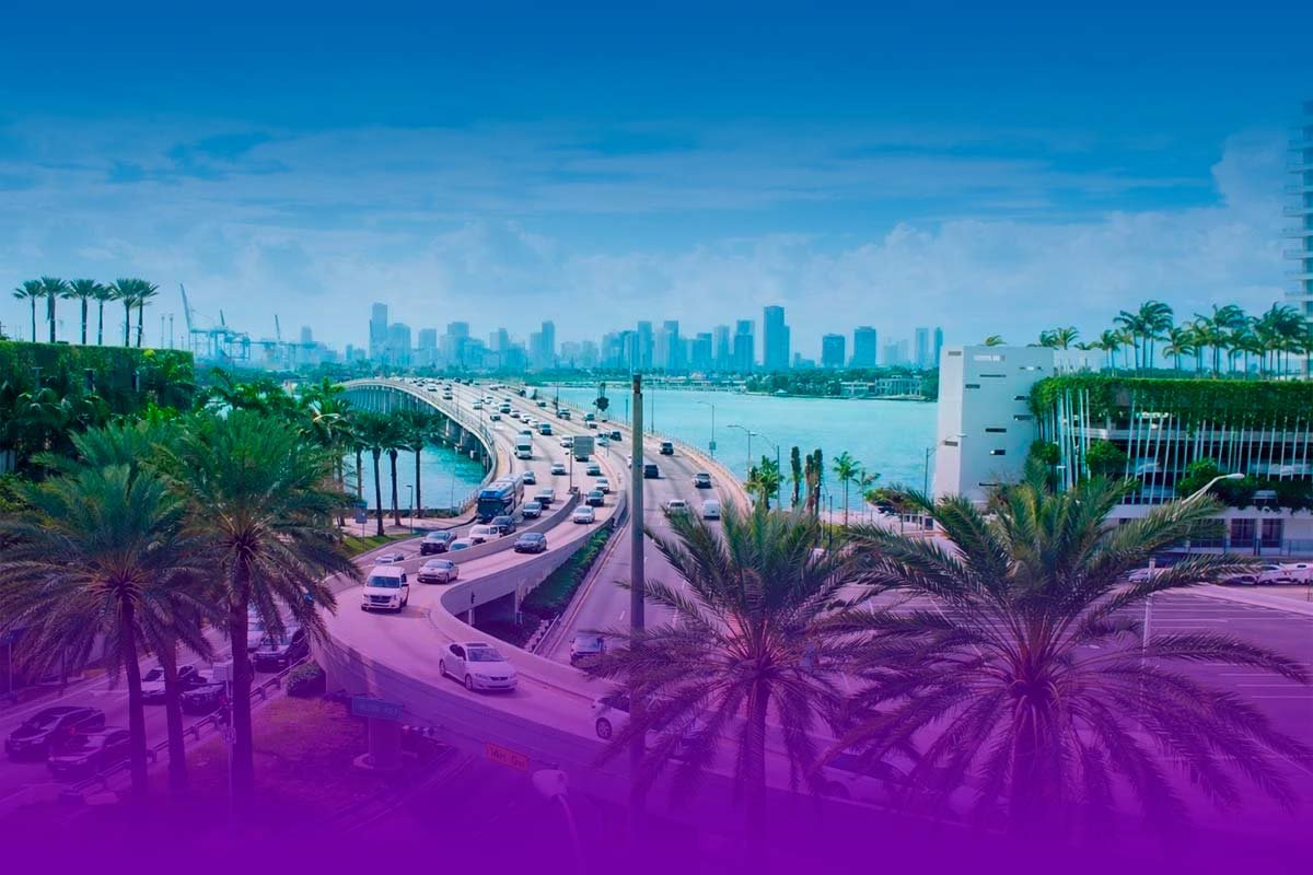 Miami skyline and bridge view with bay, palm trees, and traffic for Miami The Hype homepage