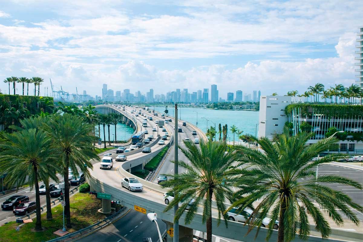 Miami skyline and bridge view with bay, palm trees, and traffic for Miami The Hype homepage