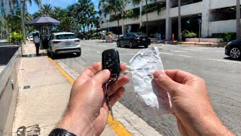 Rental car key and parking receipt showing the hidden cost of driving in Miami.