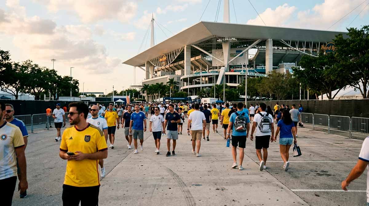 Global football fans navigating the sprawling infrastructure and pedestrian bottlenecks outside Hard Rock Stadium on a humid event matchday.