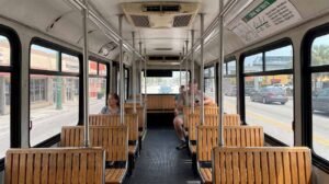 Inside the free Miami municipal trolley showing wooden seating and real transit conditions for budget travelers.
