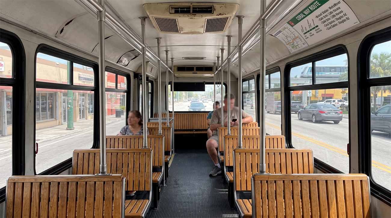 Inside the free Miami municipal trolley showing wooden seating and real transit conditions for budget travelers.
